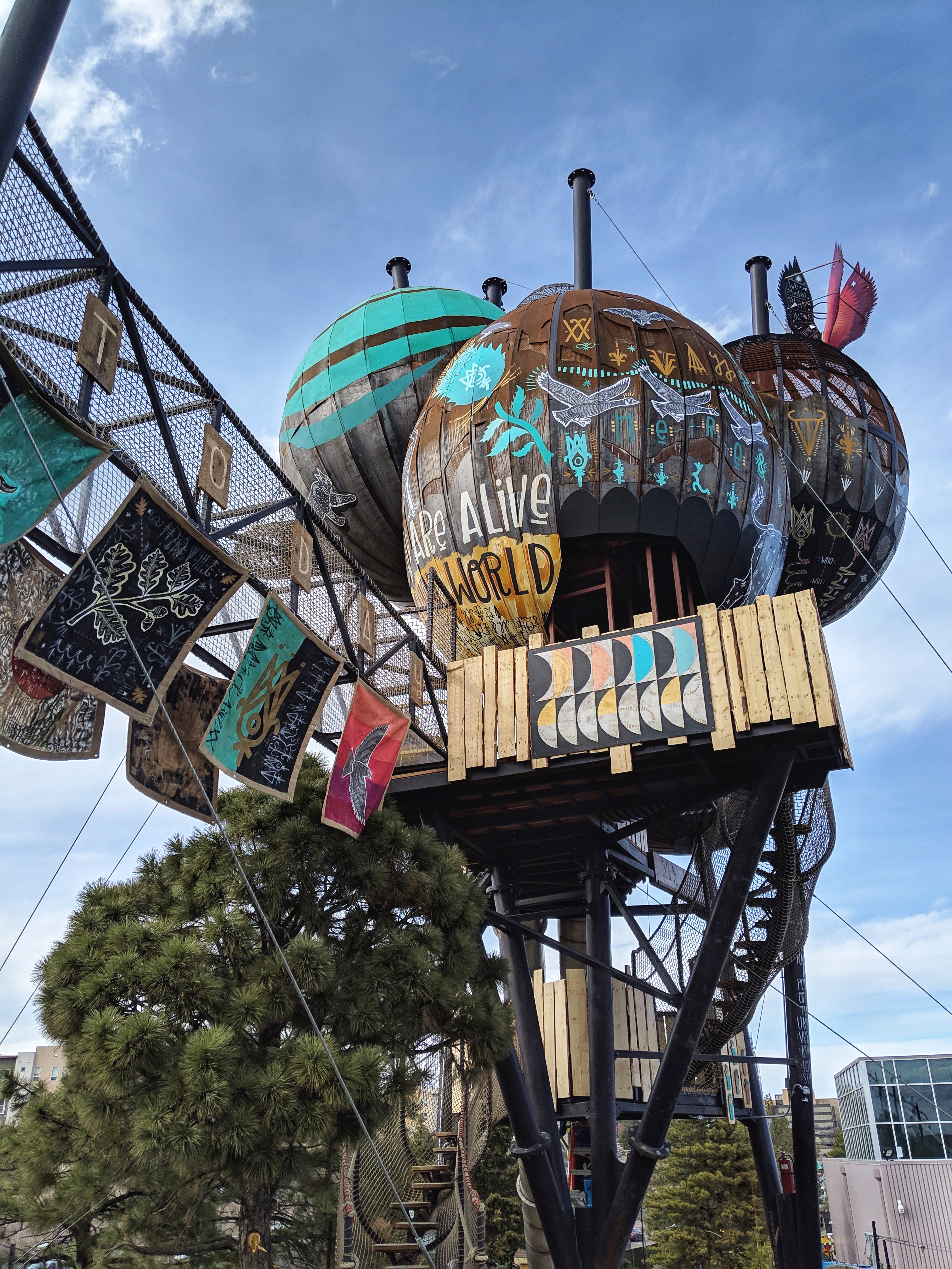 exterior of a large climbing structure covered with a nature-inspired art installation