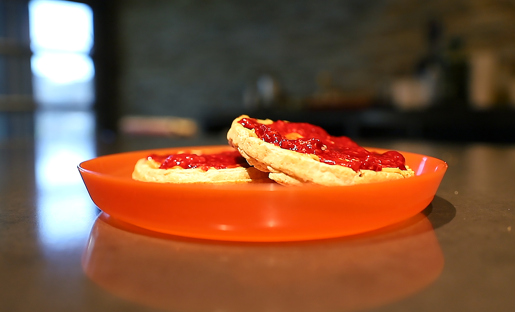 waffles with jam sitting on a plate