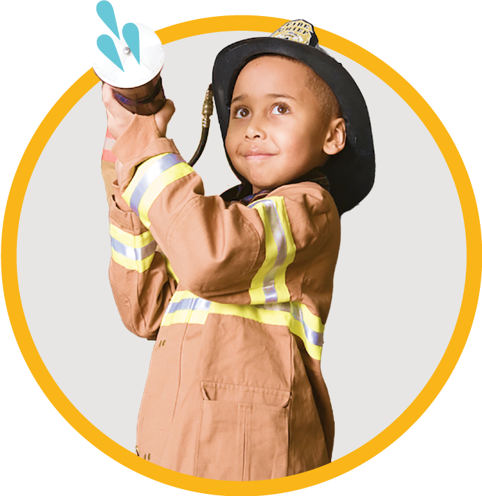 child in a fireman's hat and coat holding a fire hose